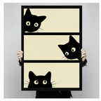 Hand-held black framed poster print of three playful black cats peeking over edges of three beige horizontal stripe panels in bold minimalist cartoon style