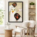 Geometric abstract pigeon family framed poster beside a Scandinavian armchair, bold mid-century modern bird wall art with gold cream background and red orange accents