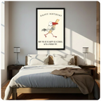 Framed canvas wall art of a cartoon seagull holding a french fry with Happy Birthday text and may you be as happy as a seagull with a french fry quote, hand-drawn illustration on cream background, above a bed with white linen bedding, a taupe throw blanket, dark wood nightstands and white table lamps in a sunlit bedroom