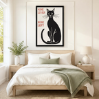 Nine Lives None Left black cat framed canvas art displayed above bed headboard in a cozy modern bedroom