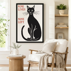 Nine Lives None Left gothic cat canvas print in black frame beside a wooden armchair in a Nordic minimal reading nook