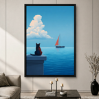 Framed canvas wall art of a black cat sitting on a stone ledge watching a red sailboat on calm blue ocean, displayed in a modern living room