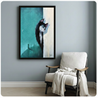 Framed art print of black tuxedo cat against teal night sky with crescent moon hung above armchair in grey room