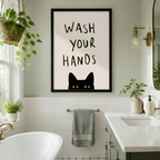 Black cat peekaboo wash your hands framed canvas in bright white tile bathroom with hanging plants and brass sconce - cat lover bathroom wall art