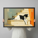 Person holding a framed black and white cat on stairs oil painting print, showing artwork scale and black frame detail