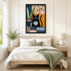 Black framed mid-century modern bohemian collage black cat coffee canvas art with a content black cartoon cat sitting and holding a steaming blue and white striped coffee cup beside a large tropical leaf plant in a dark blue striped pot on a colorful patchwork background of blush pink, deep navy, amber orange, and cream geometric color blocks with polka dot and stripe details and dangling green leaf branches, hung above a light wood bed frame in a serene Scandinavian bedroom with crisp white linen bedding, 