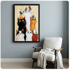 Whimsical cats and colorful birds framed art print on blue-grey wall beside white accent chair with throw blanket