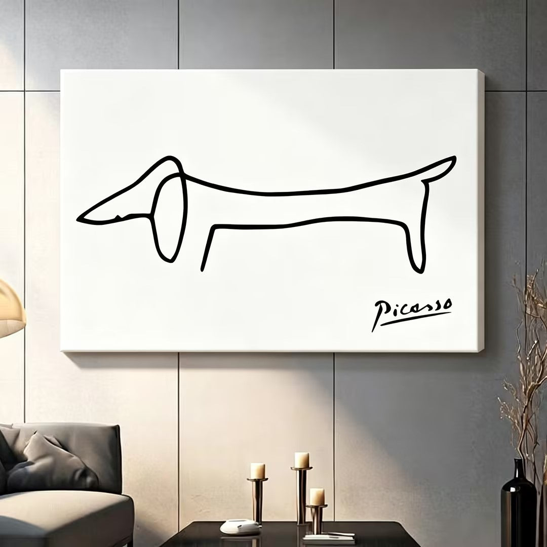 Picasso dachshund minimalist one-line drawing gallery-wrap stretched canvas displayed on dark gray paneled wall above charcoal sofa with pillar candle holders and black decorative vase