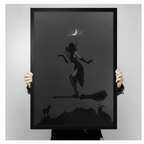 Person holding large black framed dark witch on broomstick art print, showing print size, frame width, and crescent moon detail