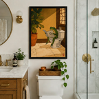 Japanese-style illustration of green frog on toilet with newspaper in black frame, styled in upscale marble bathroom with gold fixtures