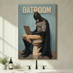 Humorous Batman on toilet using laptop Batroom canvas wrap wall art hung on a light gray bathroom wall above a black faucet sink with soap dispenser and green plant