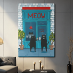 Unframed stretched canvas print of two quirky black cats in human poses holding iced coffee and a cup outside a teal brick Meow Cafe with bold red lettering and lemon and lavender potted topiaries in fun illustration style