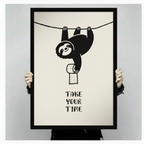 Funny sloth hanging upside down with toilet paper roll and Take Your Time quote, black framed bathroom humor poster shown in hand mockup displaying print size