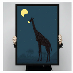 Person holding a black framed canvas print of a giraffe eating the moon at night, showing actual print size against a neutral background
