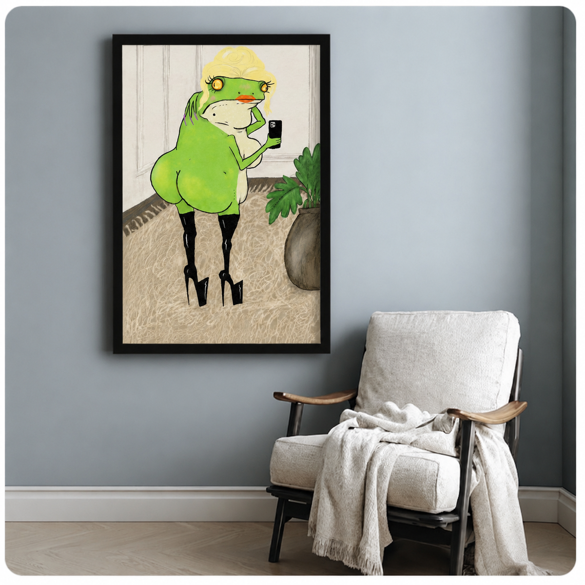 Cute funny frog in stilettos black framed poster art on light blue-gray wall beside white linen accent chair with throw blanket