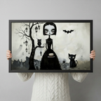 Person holding a black-framed gothic art print showing a dark whimsical girl with owl, black cat, bat and ghost silhouettes, demonstrating print size and quality

