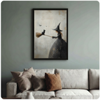 Framed gothic romantic oil painting young witch in black dress holding broomstick with black cat perched on tip and bats flying on aged cream textured background canvas print above cream sofa on sage blue-grey wall - whimsical Halloween witch and black cat broom wall art for stylish living room decor