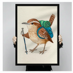Person holding a large black framed whimsical watercolor art print depicting a Carolina wren with a teal hiking backpack, green sleeping roll, and blue trekking pole on a cream textured background, showcasing print detail and frame quality
