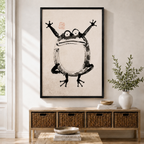Framed Japanese ink wash frog wall art displayed above a wicker storage console in a bright Scandinavian-style entryway
