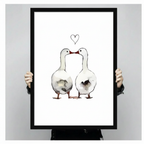 Hands holding a large black framed canvas print of two white geese touching beaks with a heart drawn above them in fine line art, ink wash illustration on white background against a light gray backdrop