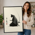Smiling woman holding large black framed Japanese samurai cat ink wash art print showing artwork size and scale