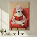 Humorous framed canvas print of white cat wearing glasses and pink towel wrap reading a book in red armchair