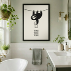 Smiling sloth dangling from rope holding toilet paper with Take Your Time motivational quote, black framed funny wall art print in bright bathroom with freestanding bathtub