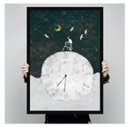 Person holding a large black framed surrealist illustration canvas art print showing print size scale with a small figure on a ladder atop a giant white Roman numeral clock under a golden crescent moon with white birds on a deep teal night sky