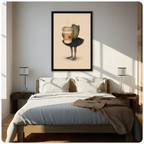 Black framed vintage illustration green frog wearing black ballet skirt hugging oversized coffee cup canvas art on warm beige background above a bed with white linen bedding, a taupe throw blanket, dark wood nightstands, and white cylindrical table lamps in a sunlit modern bedroom