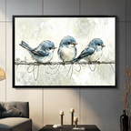 Three fluffy blue birds perched on a wire, watercolour framed canvas art displayed on a dark gray living room wall above a console table with candles