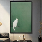 Minimalist white cat sitting on wooden perch against sage green textured background framed wall art - Japanese wabi-sabi style cat canvas print for modern living room decor