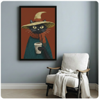 Black cat witch art print in black frame on grey wall above armchair, whimsical cottagecore style wall decor