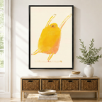 Happy dancing yellow bird framed canvas print displayed above wicker storage bench in a bright modern American entryway